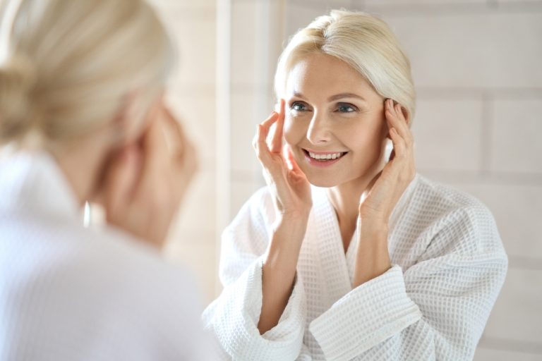 blonde senior woman mirror