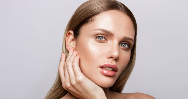 Woman with glowing skin and defined brows and lips.